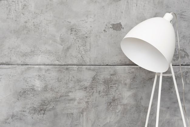 Photo close-up minimalist white floor lamp with concrete panels