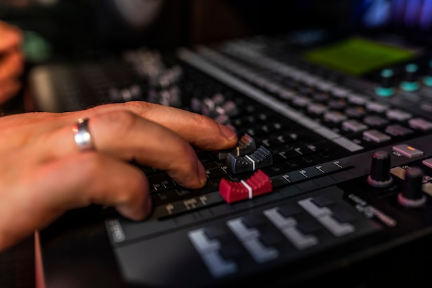 Close up mixer in the record studio where song writer is making his new mix