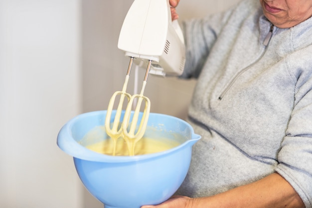 Close up mixing biscuit dough with a electric mixer. Shallow deep of field