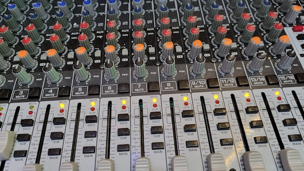 A close up of a mixing board with the number 12 on it