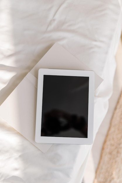 Close-up of mobile phone on bed at home