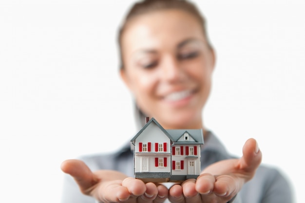 Close up of model house being held by female estate agent