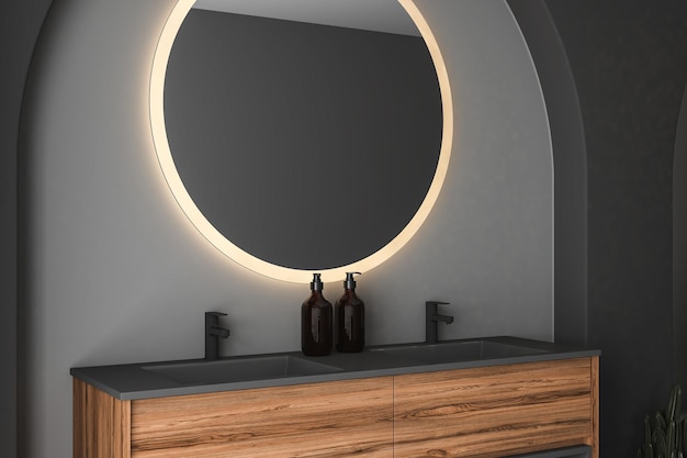 Закройте современную черную мебель для ванной комнаты, висящую на темной стене, с аксессуарами, овальным зеркалом.