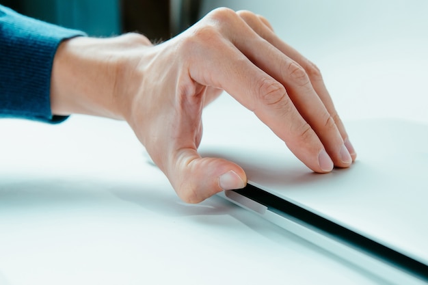 Close up modern man opening his laptop