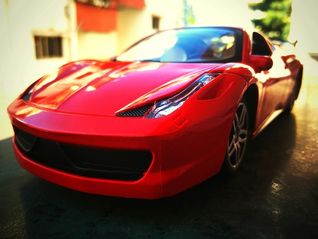 Close-up of modern red car on street