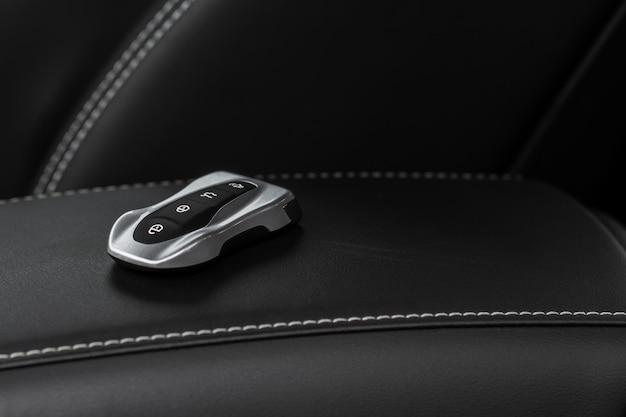 Close up of a modern wireless car key. modern car\
interior.