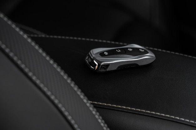 Close up of a modern wireless car key. modern car
interior.