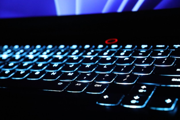 Photo close up monitor and backlit keyboard concept photo keys with glowing elements