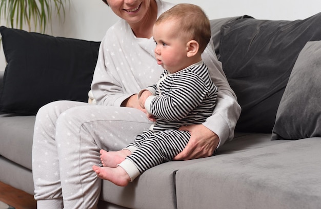 Close up of a mother and baby sitting on the sofa