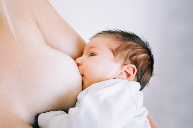 Close-up of mother breastfeeding daughter