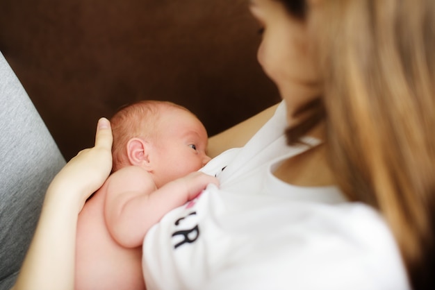 Close up of mother breastfeeding newborn baby