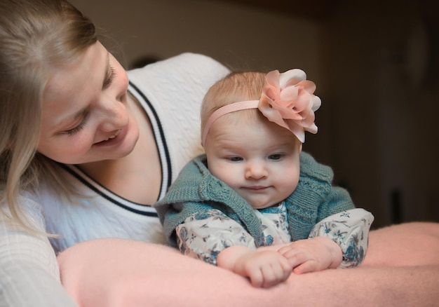 close-up of mother embracing cute baby girl