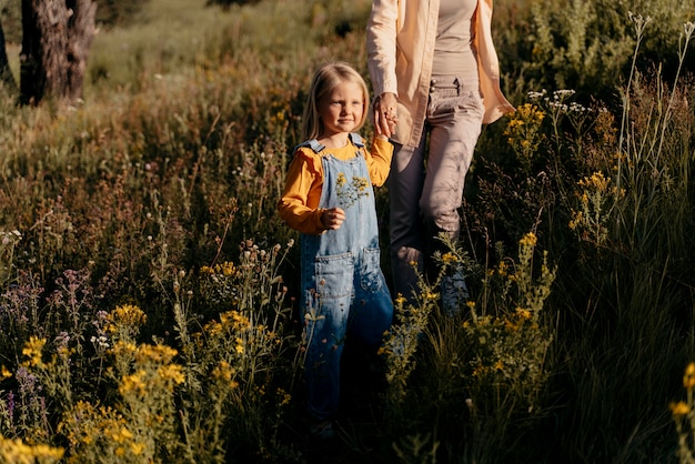 Close up mother and girl holding hands