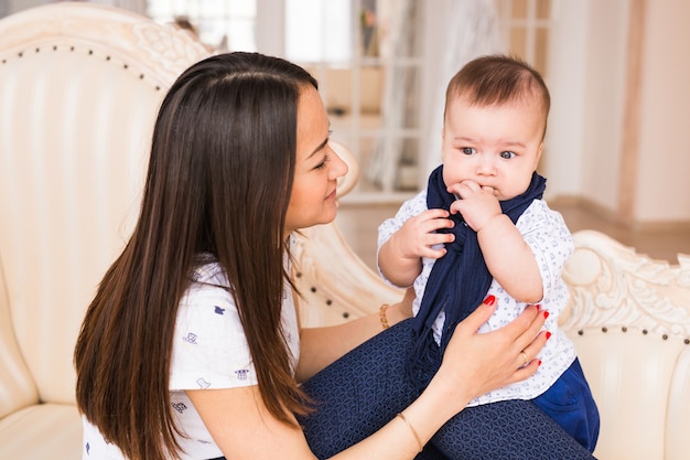 Close up of mother holding newborn baby in arms