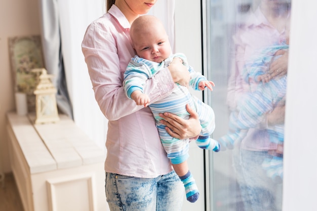 Close up of mother holding newborn baby in arms