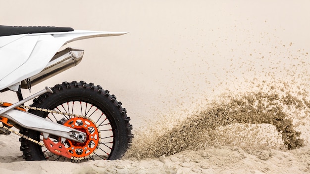 Foto motocicletta del primo piano che guida nel deserto