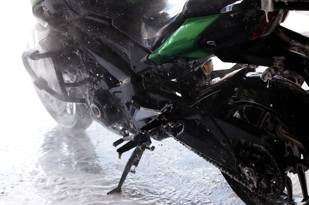 Close-up motorcycle at a car wash in the water