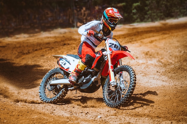 Close-up of mountain motocross race in dirt track in day time