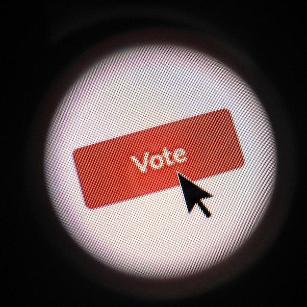 Photo close-up of mouse pointer on vote text