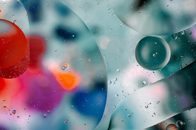 Close-up of the movement of oil droplets on the water surface. colorful abstract macro background of oil drops on the water surface