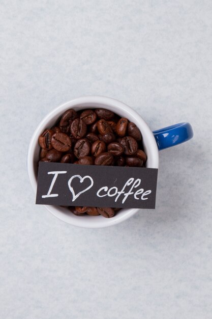 Close up mug with coffee beans