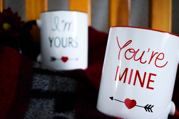 Photo close-up of mug with texts on blanket