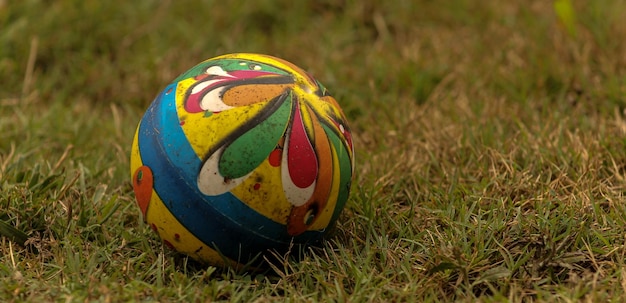 Close-up of multi colored ball on field