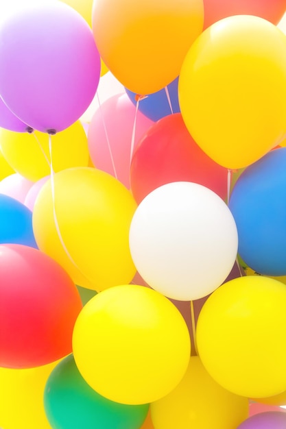 Close-up of multi colored balloons against sky