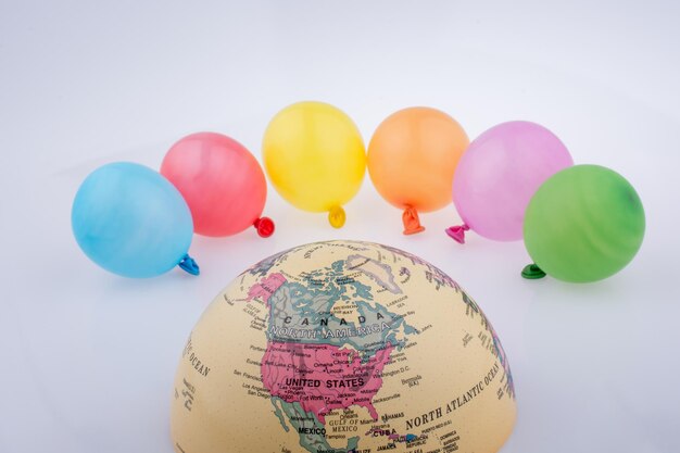 Photo close-up of multi colored balloons against white background