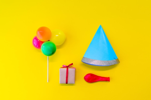 Close-up of multi colored balloons against yellow background