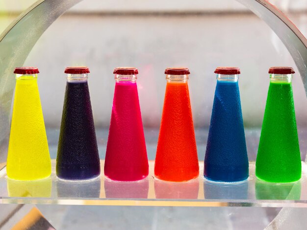 Close-up of multi colored bottles on table