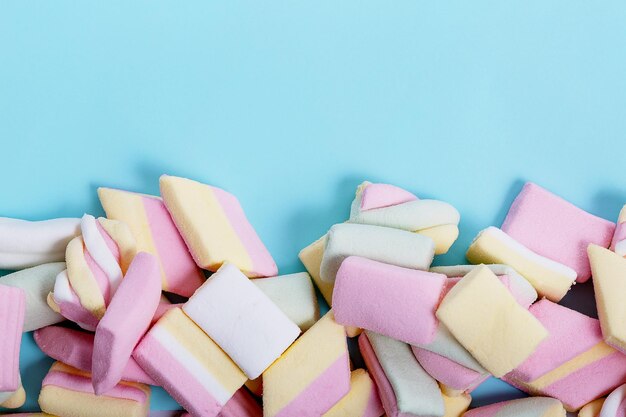 Close-up of multi colored candies against blue background