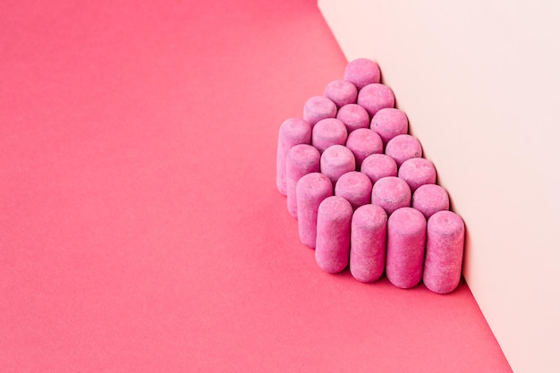 close-up of multi colored candies against pink background