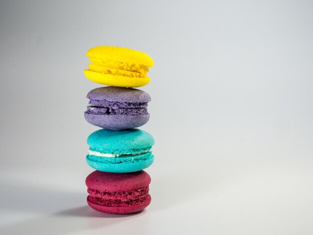 Photo close-up of multi colored candies against white background