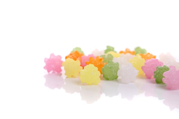 Close-up of multi colored candies against white background