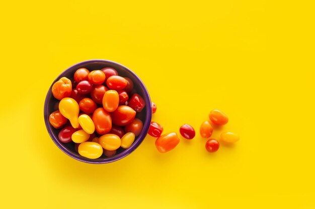 Close-up of multi colored candies against yellow background