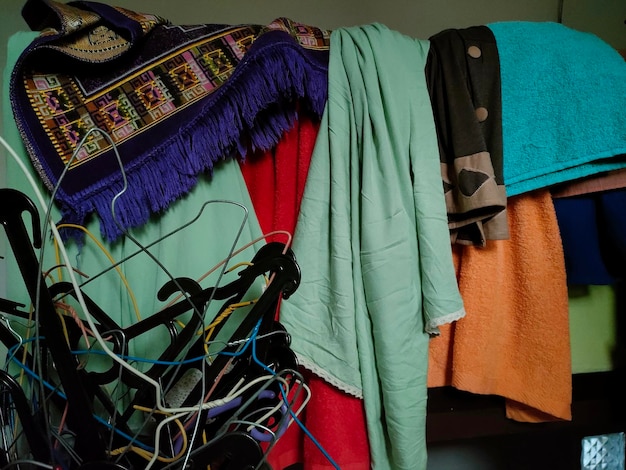 Photo close up of multi-colored clothes hanging on the banister of the house