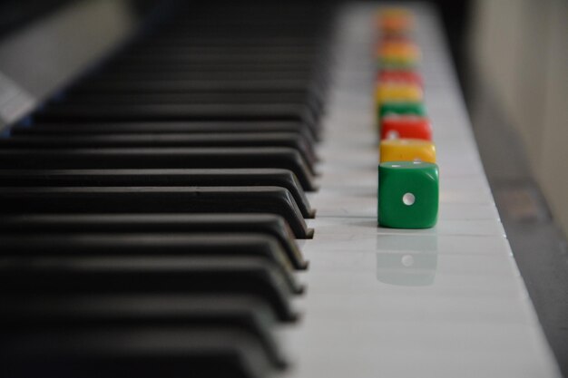 Photo close-up of multi colored dices on piano