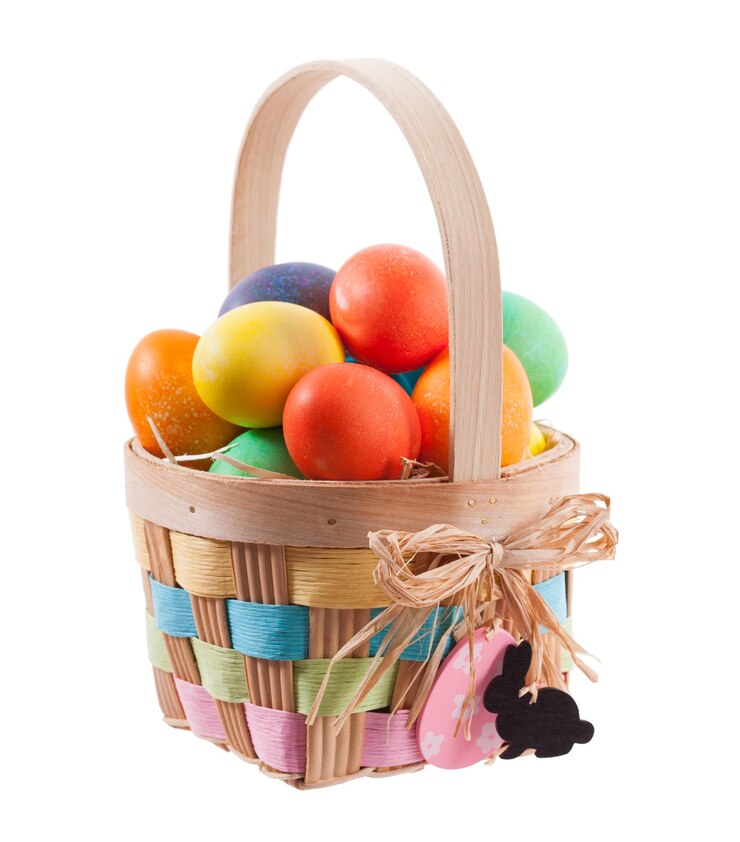 Photo close-up of multi colored easter eggs in basket against white background