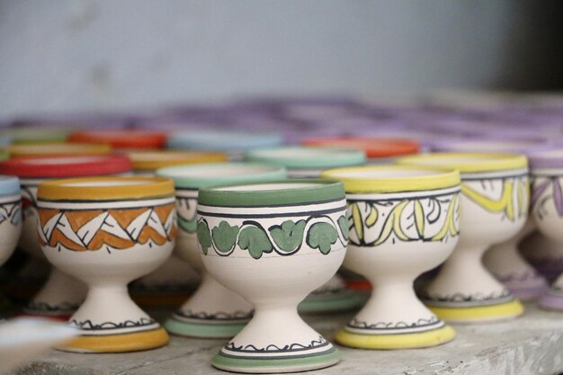 close-up of multi colored egg cups on table