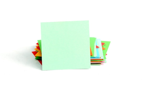 close-up of multi colored papers over white background