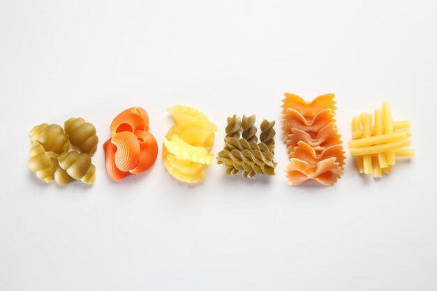 Close-up of multi colored pasta on white background