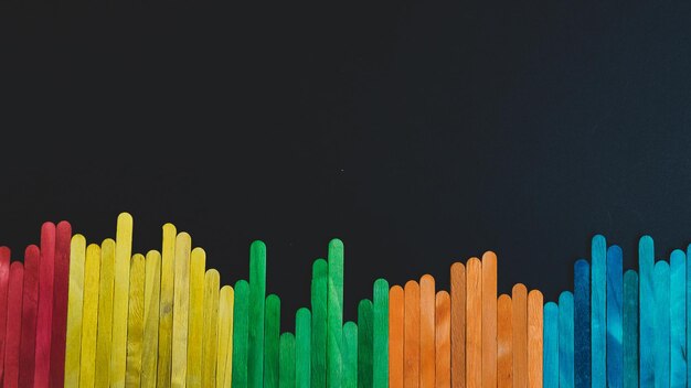 Photo close-up of multi colored pencils against black background