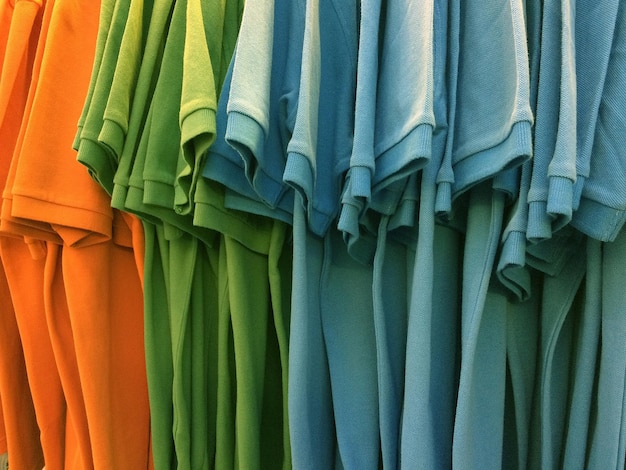 Photo close-up of multi colored t-shirts hanging for sale