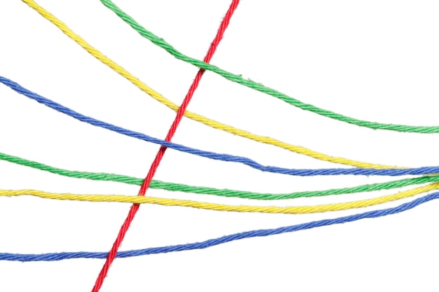 Close-up of multi colored threads against white background