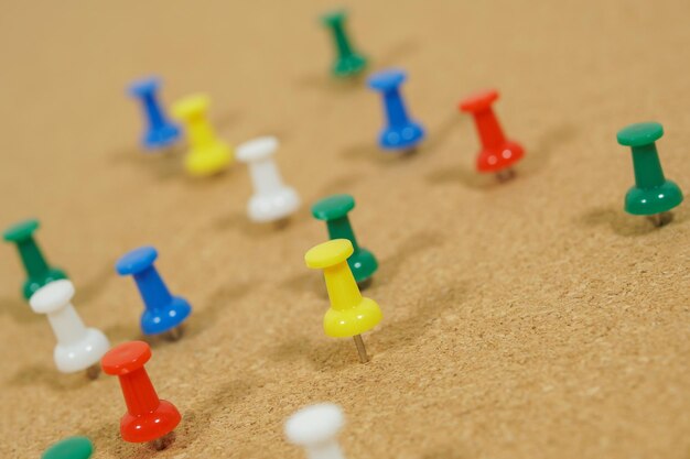 Close-up of multi colored thumbtacks on bulletin board