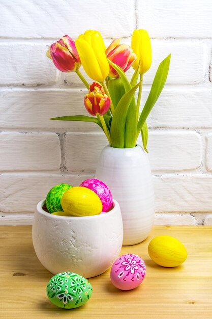 close-up of multi colored tulips in vase on table