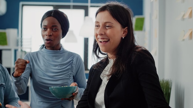 Close up of multi ethnic people having fun with drinks and
foosball game table after work. workmates enjoying free time with
beer and snacks for entertainment after hours at office