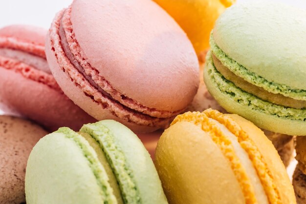 Close up of multicolor macarons french macaroon greedy pastry on white background macarons dessert f