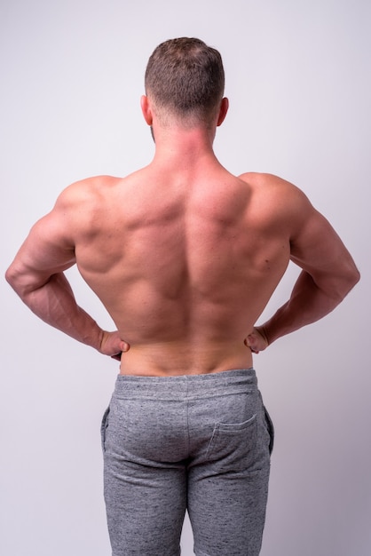 close up of muscular bearded man shirtless isolated